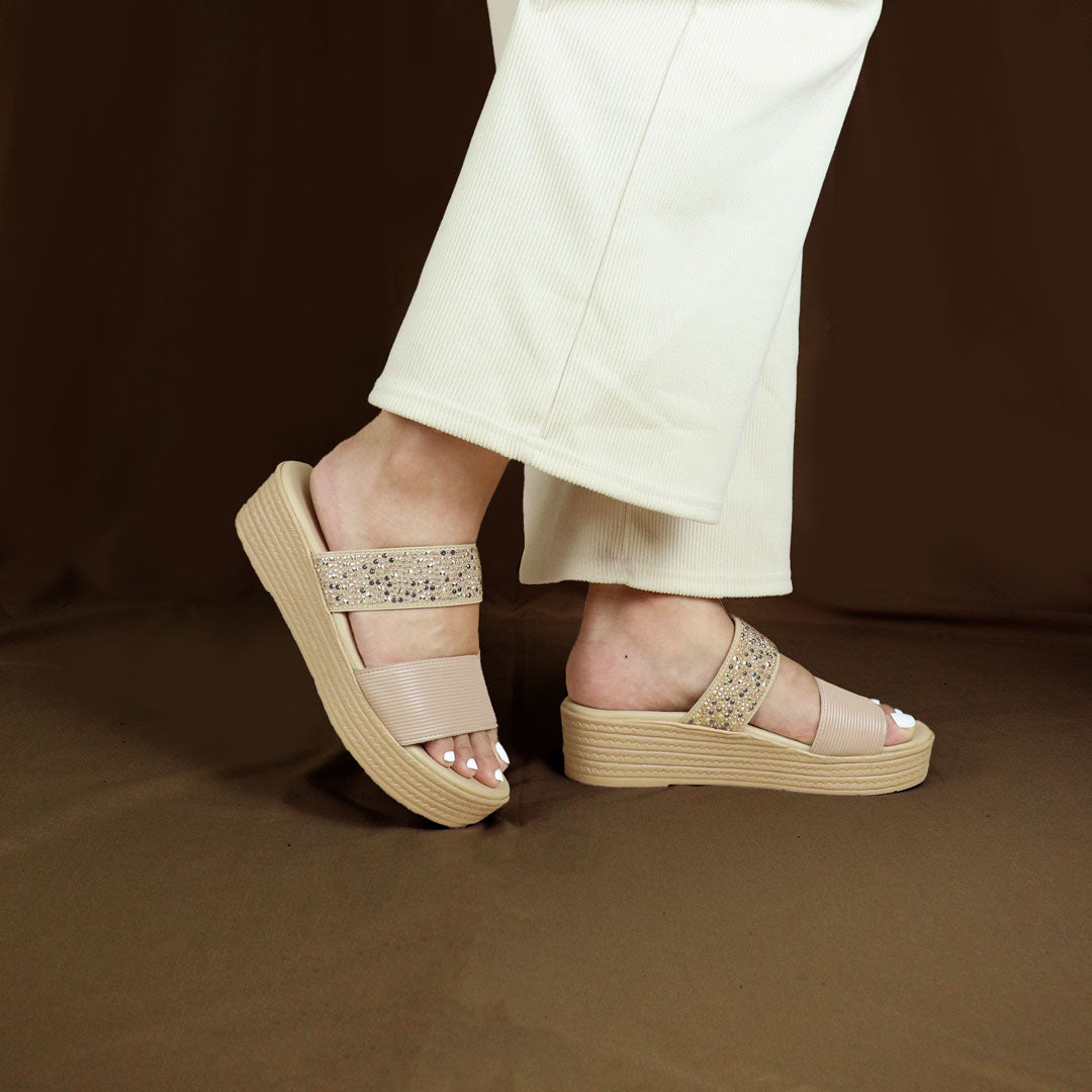 Model wearing size 37  Thomas Chan Boho Rhinesstone Flatform sandals in cream from the standing side view, featuring a comfort footbed. The platform, with a cream braided element, measures 3cm at the front and 5cm at the back, set against  bronze coloured backdrop