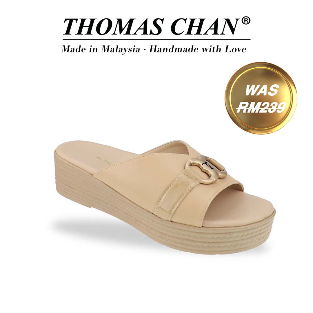 Diagonal view of the Thomas Chan Minimalist Buckle Flatform Sandals in cream, showcasing an elegant infinity buckle with the signature 'T' logo and a cushioned footbed for ultimate comfort. The 'THOMAS CHAN®' brand is prominently displayed with the inscription 'Made in Malaysia · Handmade with Love' beneath. A gold and white banner highlights a special offer: 'Was RM239'