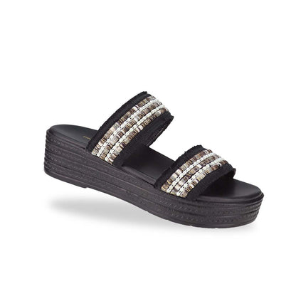 Diagonal view of Thomas Chan Summer Love Boho low platform sandals in black and little white embroidery, featuring a comfort footbed. The platform, with a black braided element, measures 3cm at the front and 5cm at the back.