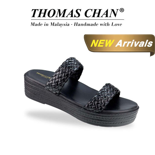 Diagonal view of Thomas Chan Braided Strap Flatform Sandals in black, featuring a comfort cushioned footbed. 'THOMAS CHAN®' brand displayed with 'Made in Malaysia · Handmade with Love' below. A gold and white banner highlights a special offer: 'New Arrival"