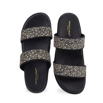 Front view of the Thomas Chan Strappy Rhinestone Flatform Sandals in black, featuring two elegant rhinestone-adorned straps and a cushioned footbed designed for maximum comfort. The platform, with a black braided element, measures 3cm at the front and 5cm at the back.