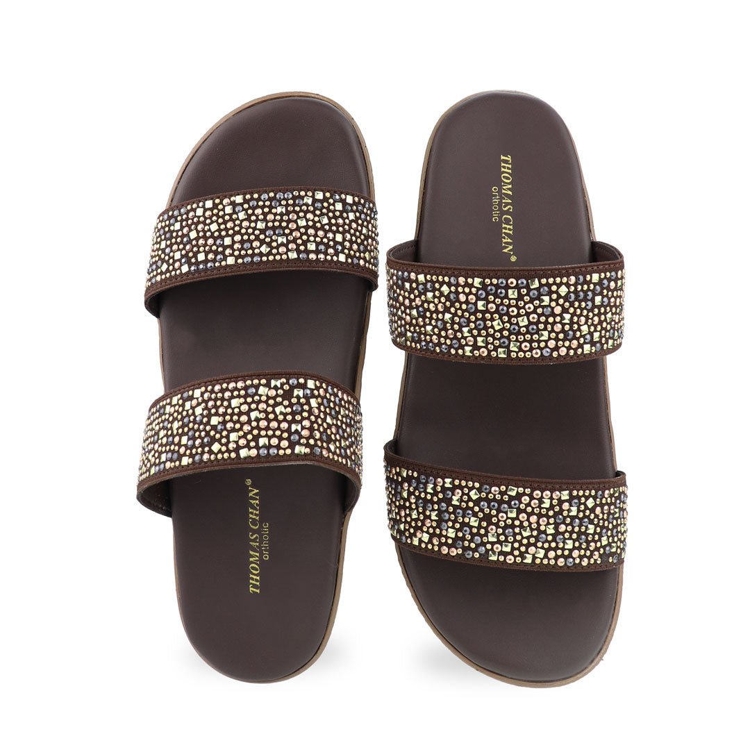 Front view of the Thomas Chan Strappy Rhinestone Flatform Sandals in brown, featuring two elegant rhinestone-adorned straps and a cushioned footbed designed for maximum comfort. The platform, with a light brown braided element, measures 3cm at the front and 5cm at the back.