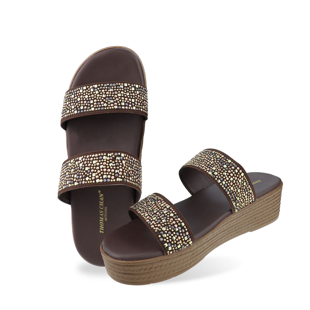 Full view of the Thomas Chan Strappy Rhinestone Flatform Sandals in brown, featuring two elegant rhinestone-adorned straps and a cushioned footbed designed for maximum comfort. The platform, with a light brown braided element, measures 3cm at the front and 5cm at the back.