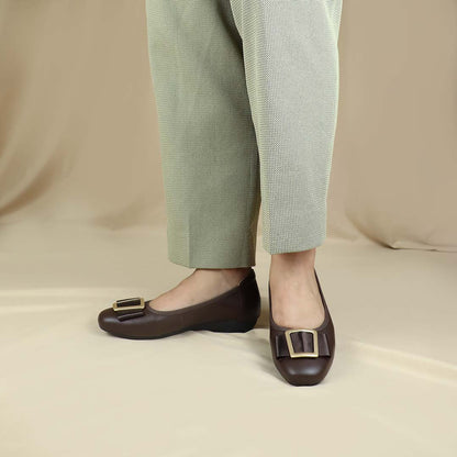 A model wearing the dark brown colour Thomas Chan's Soft Calf Leather Ribbon Ballet Pumps in a studio setting, paired with office attire, demonstrating their elegant and professional appearance.