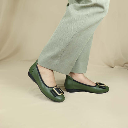 A model wearing the deep green colour Thomas Chan's Soft Calf Leather Ribbon Ballet Pumps in a studio setting, paired with office attire, demonstrating their elegant and professional appearance.