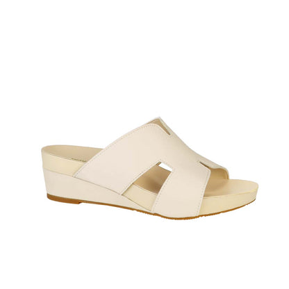 Diagonal view of Thomas Chan ivory cream colour comfortable Pebble Lychee H-Strap Low Wedge Slides sandals with arch support footbed