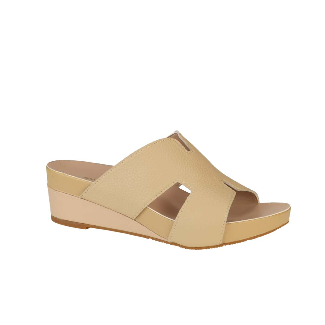 Diagonal view of Thomas Chan mustard cream colour comfortable Pebble Lychee H-Strap Low Wedge Slides sandals with arch support footbed