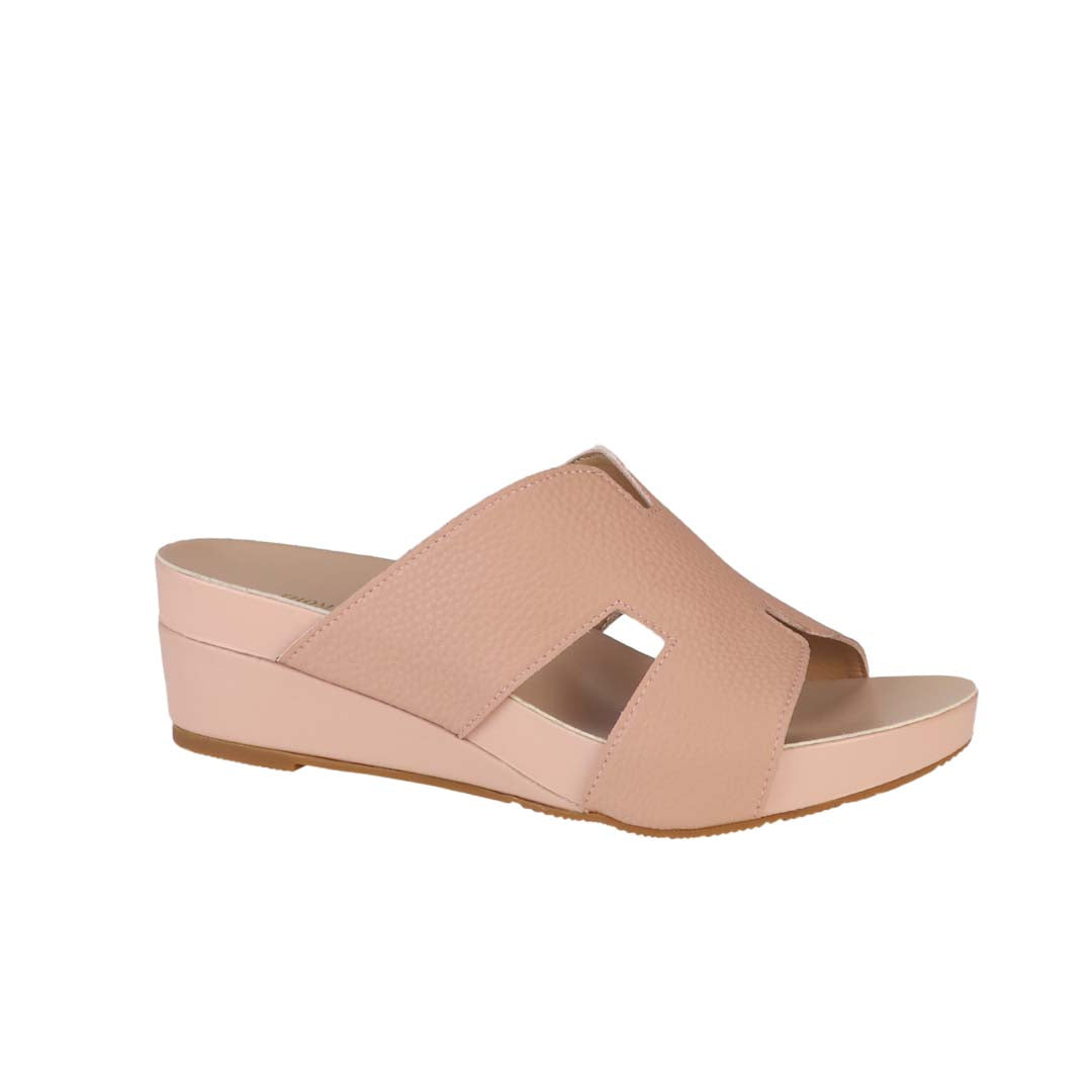 Diagonal view of Thomas Chan peachy pink colour comfortable Pebble Lychee H-Strap Low Wedge Slides sandals with arch support footbed