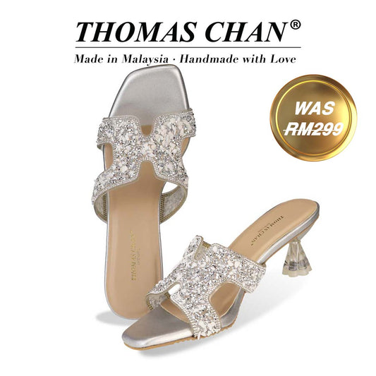 Thomas Chan's Sparkle Jewel H-Strap Heeled Sandals in silver colour, featuring an elegant design and a uniquely designed heel. "THOMAS CHAN®" brand displayed with "Made in Malaysia · Handmade with Love" below. Gold and white banner highlights special offer: "Was RM299"