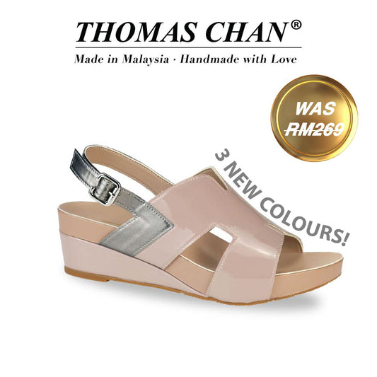 Thomas Chan H-Strap Slingback Low Wedge Sandals in Light taupe, featuring a silver patent slingback and built-in arch-support footbed. "3 NEW COLOURS!" listed around the shoe, "THOMAS CHAN®" brand displayed with "Made in Malaysia · Handmade with Love" below. Gold and white banner highlights special offer: "WAS 269."