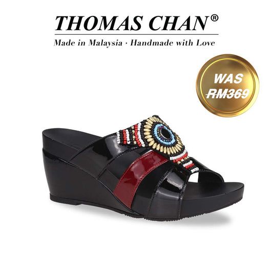 Thomas Chan's Triple Strap Bead Wedges in black and red patent feature colorful bead embellishments and a 3-inch wedge heel. Designed with built-in arch-support footbed technology for enduring comfort, these wedges are as stylish as they are supportive. A gold badge proudly displays the original price of RM 369, complemented by text celebrating "THOMAS CHAN® Made in Malaysia · Handmade with Love."