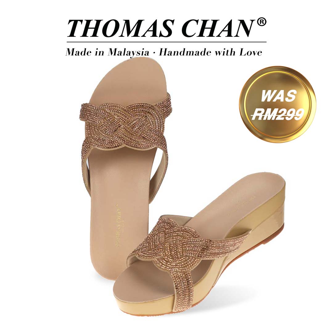 Thomas Chan Diamond Knot-Decor Slide on Sandals in gold, featuring an elegant design and arch-support footbed. "THOMAS CHAN®" brand displayed with "Made in Malaysia · Handmade with Love" below. Gold and white banner highlights special offer: "WAS 299."