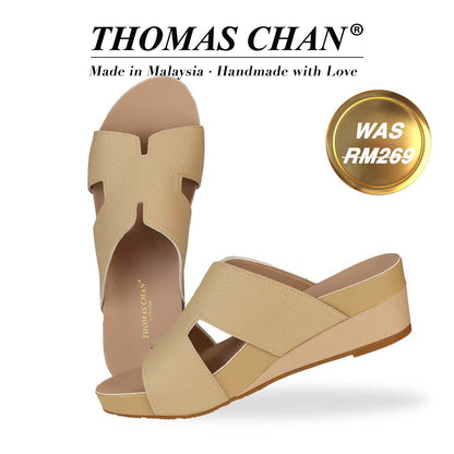 Thomas Chan Pebble Lychee H-Strap Low Wedge Slides in rosy mustard cream, featuring an arch-support footbed. The "THOMAS CHAN®" brand is displayed with "Made in Malaysia · Handmade with Love" below. A gold and white banner highlights a special offer: "Was RM269."