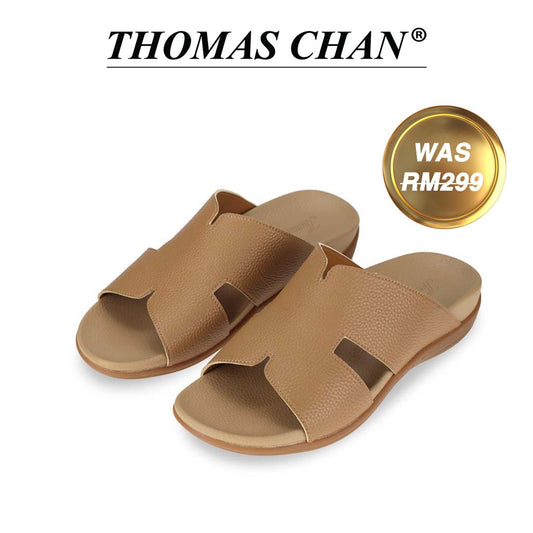 The image features Thomas Chan's Men Classic H-Strap Leather Sandals in camel with its arch-support footbed. The top of the image displays the brand name "THOMAS CHAN®" with the text "Made in Malaysia · Handmade with Love" below it. There is a gold and white banner on the right side that says "WAS 299."