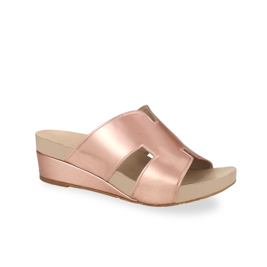 Diagonal view of Thomas Chan rose gold colour comfortable H-strap low wedge slide sandals with arch support