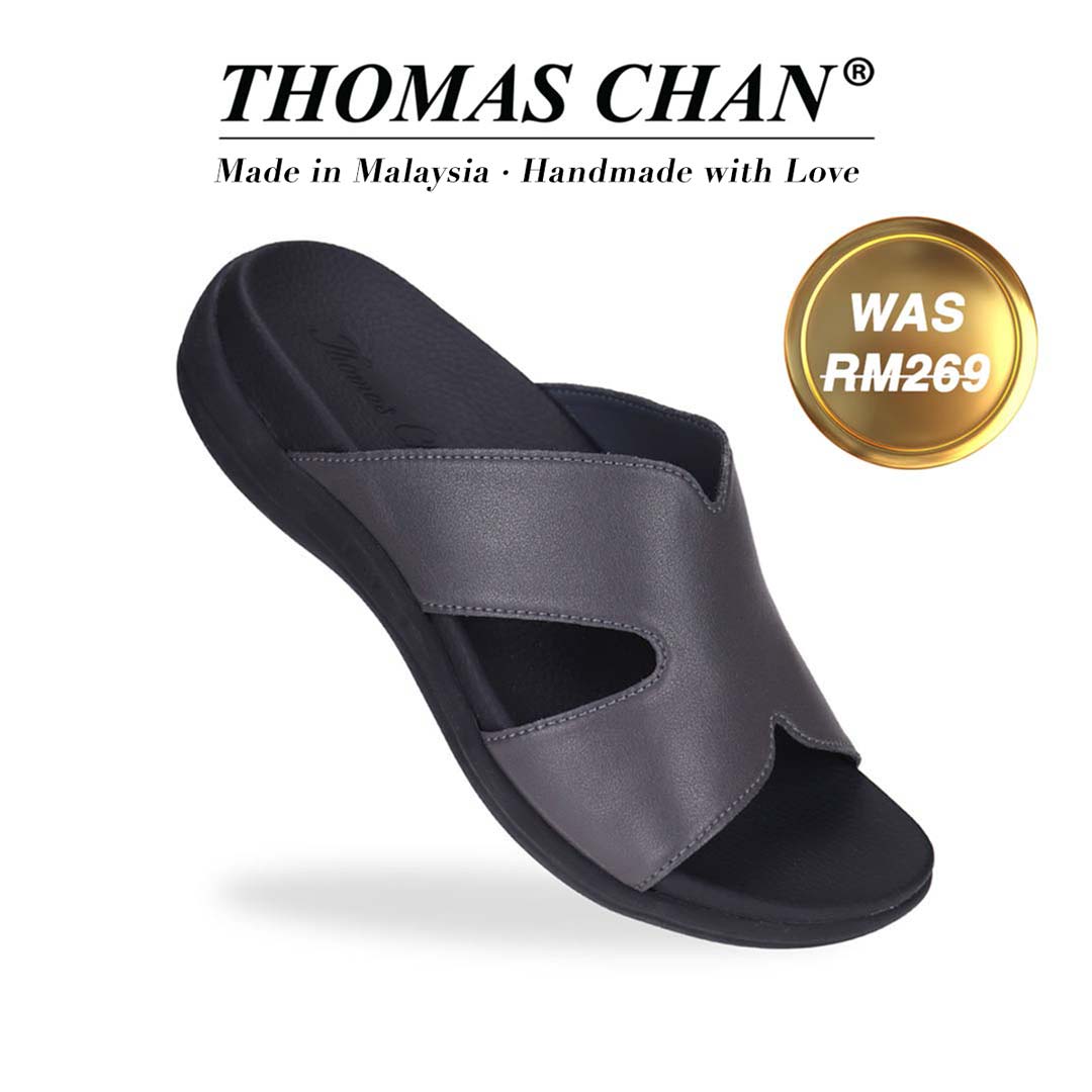 Thomas Chan's Ultra Comfort Matte Leather Sandals in grey, displaying an elegant design with an arch-support footbed. "THOMAS CHAN®" brand prominently shown with "Made in Malaysia · Handmade with Love" below. Gold and white banner highlights special offer: "WAS 269."