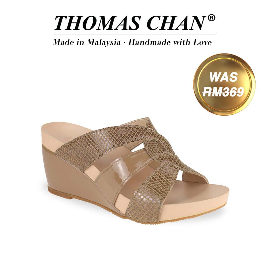 Introducing Thomas Chan's Triple Straps Snake-Effect Wedges, featuring a striking snake print design and a 3-inch wedge heel. Designed with built-in arch-support footbed technology for enduring comfort, these sandals are as stylish as they are supportive. A gold badge proudly displays the original price of RM 369, complemented by text celebrating "THOMAS CHAN® Made in Malaysia · Handmade with Love."