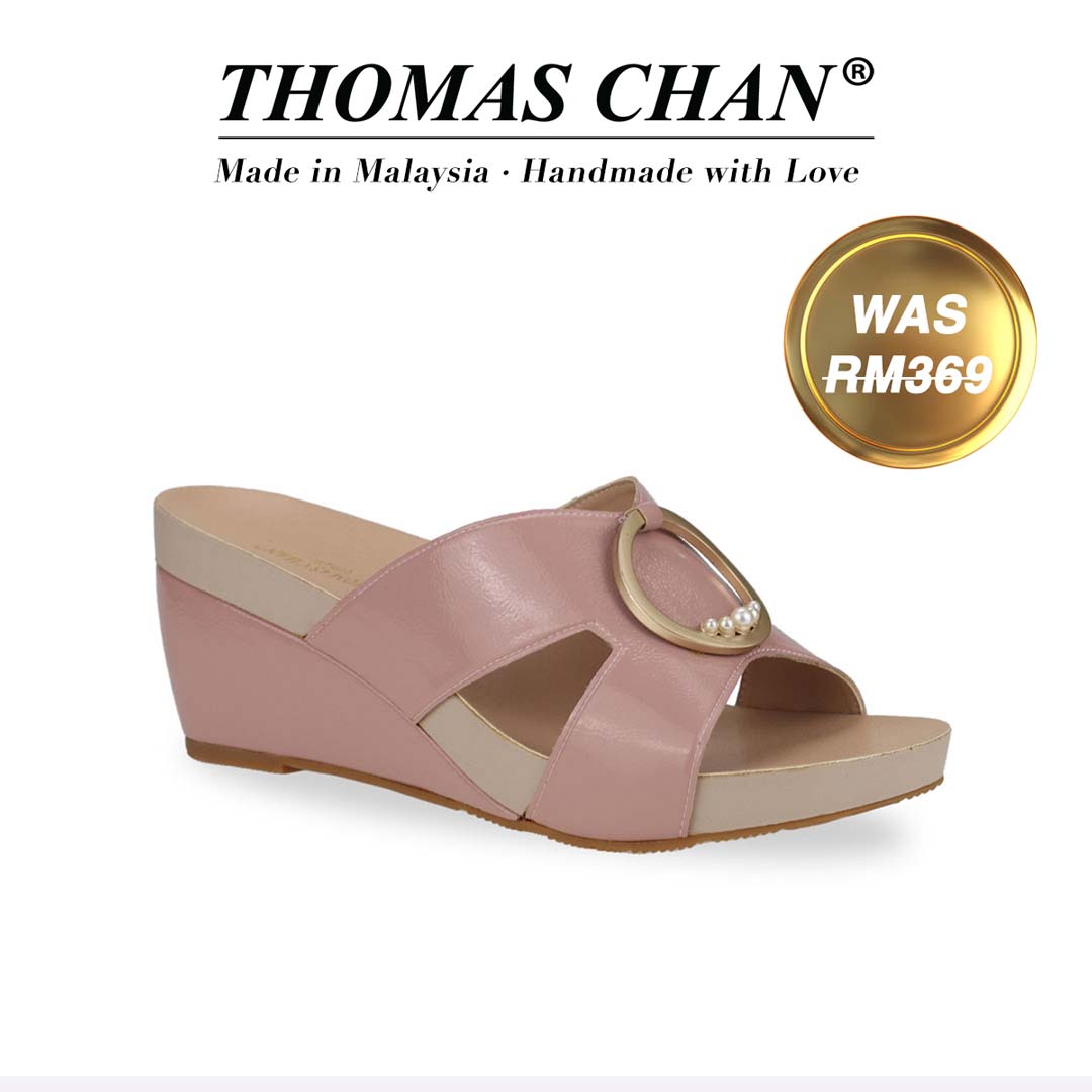  Thomas Chan's Minimalist Decor Orthotic Wedge Sandals in pink offer effortless style with their slip-on design and 3-inch wedge heel. They are equipped with built-in arch-support footbed technology for enduring comfort. A gold badge displays the original price of RM369, with accompanying text above celebrating "THOMAS CHAN® Made in Malaysia · Handmade with Love."