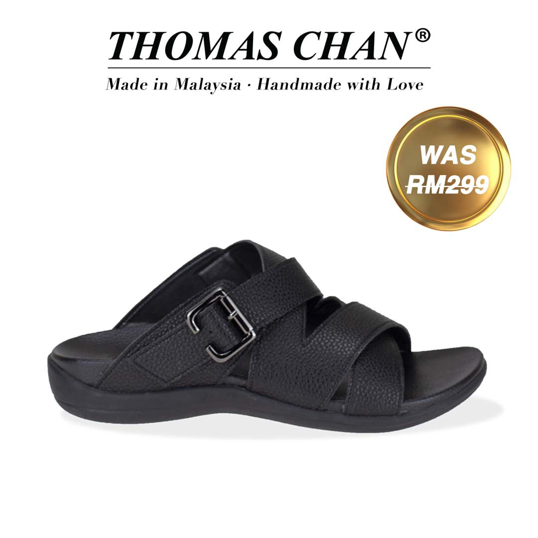 An image of Thomas Chan's Men Multi Straps Buckle Sandals in black colour, featuring an arch-support footbed. The top of the image displays the brand name "THOMAS CHAN®" with the text "Made in Malaysia · Handmade with Love" below it. A gold and white banner on the right side states "WAS 299."