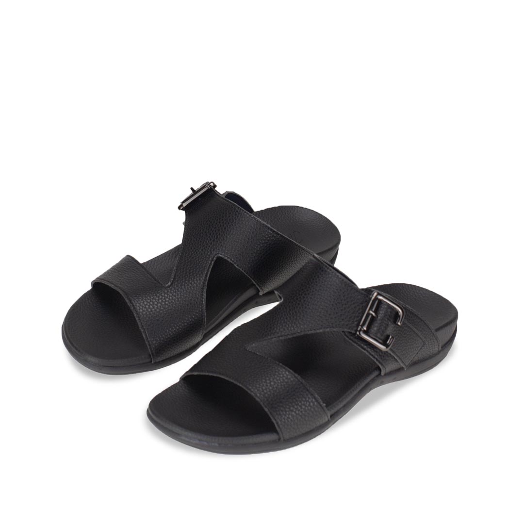 Diagonal view of comfortable men's black leather sandals with orthotic arch support footbed, featuring a special zig-zag design with buckle by Thomas Chan