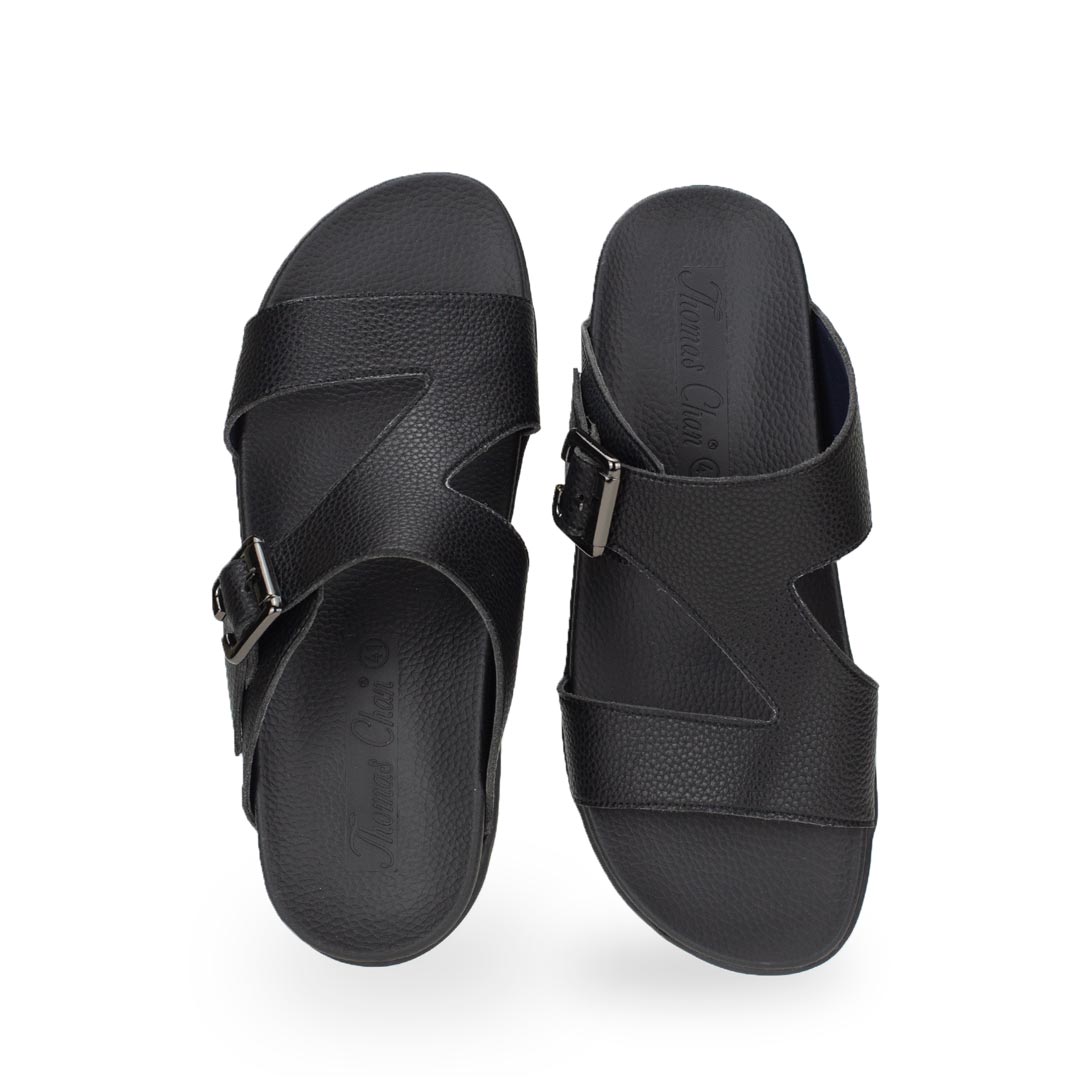 Front view of comfortable men's black leather sandals with orthotic arch support footbed, featuring a special zig-zag design with buckle by Thomas Chan