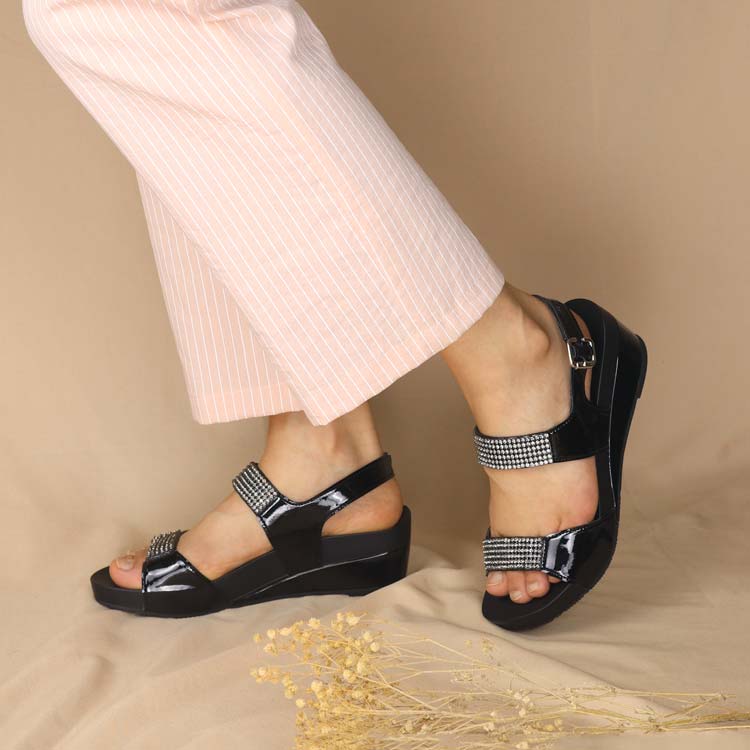 middle-aged woman wearing Thomas Chan classy black diamond strap sling back dinner sandals