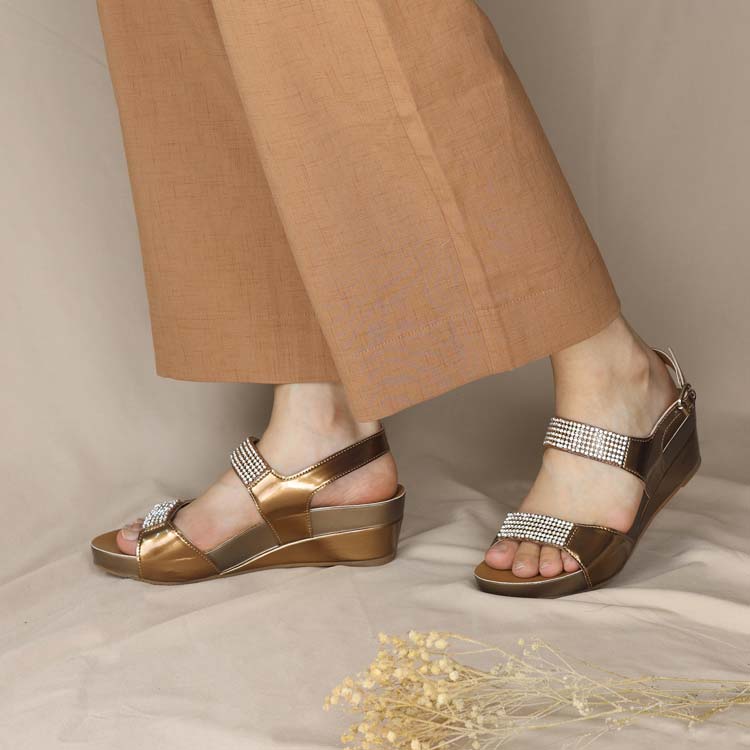 Comfortable bronze colour dinner low wedges in diamond straps and sling back design adding an elegant yet classy look to your outfit