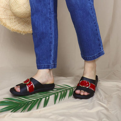 Model wearing Thomas Chan PU slide sandals with basic logo buckle in black, featuring a mixture of red patent in the middle and in-built soft arch support insoles.